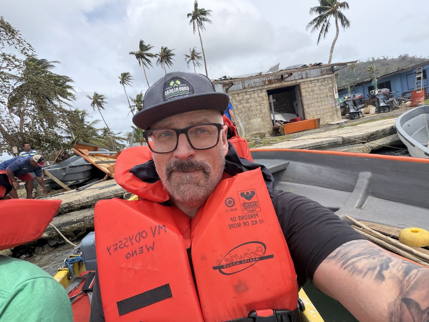 Alan in a life jacket amid storm debris, finally headed to the boat